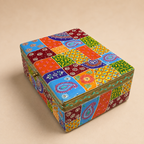 Angled view of the colourful patchwork lid and patterned sides of the larger decorative storage box