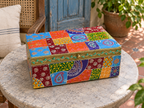 Colourful paisley and floral storage box displayed on a round stone table
