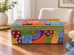 Multicolour Rangoli Patchwork storage box displayed on a sunlit wooden table beside a vase