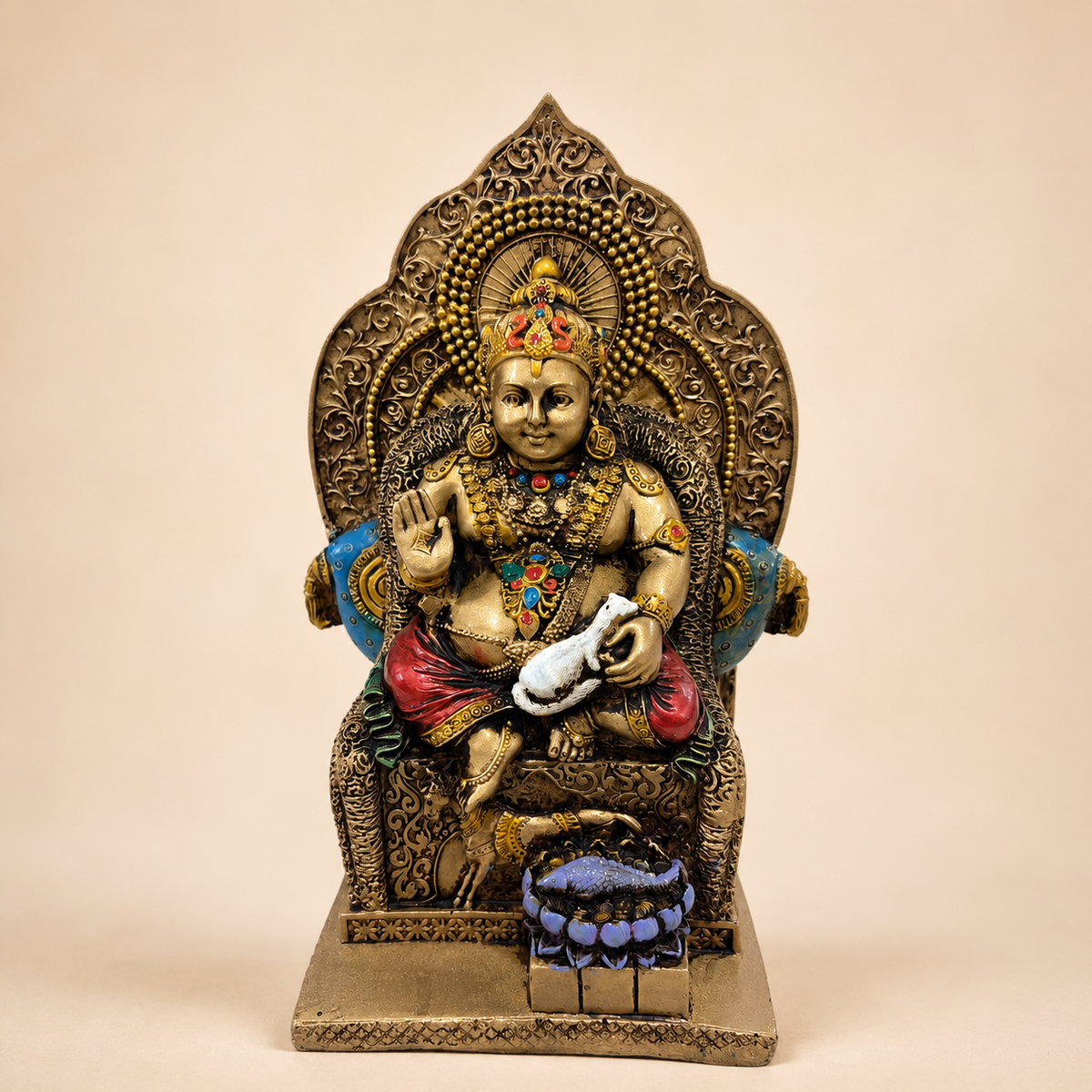 Lord Kuber idol seated on an ornate throne with gold-tone finish, red drapery, blue accents and a white mongoose, front view