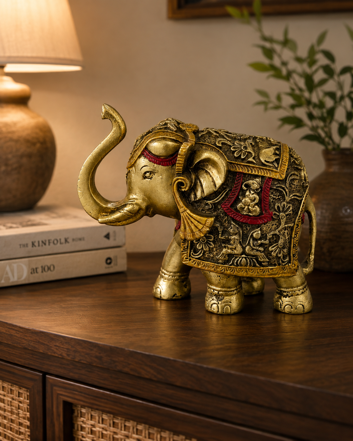 Regal Heritage gold and red elephant sculpture styled on a dark wood console