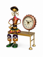 Colourful folk drummer table clock shown from an angled view
