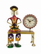 Colourful folk drummer sculpture with analog table clock, front view