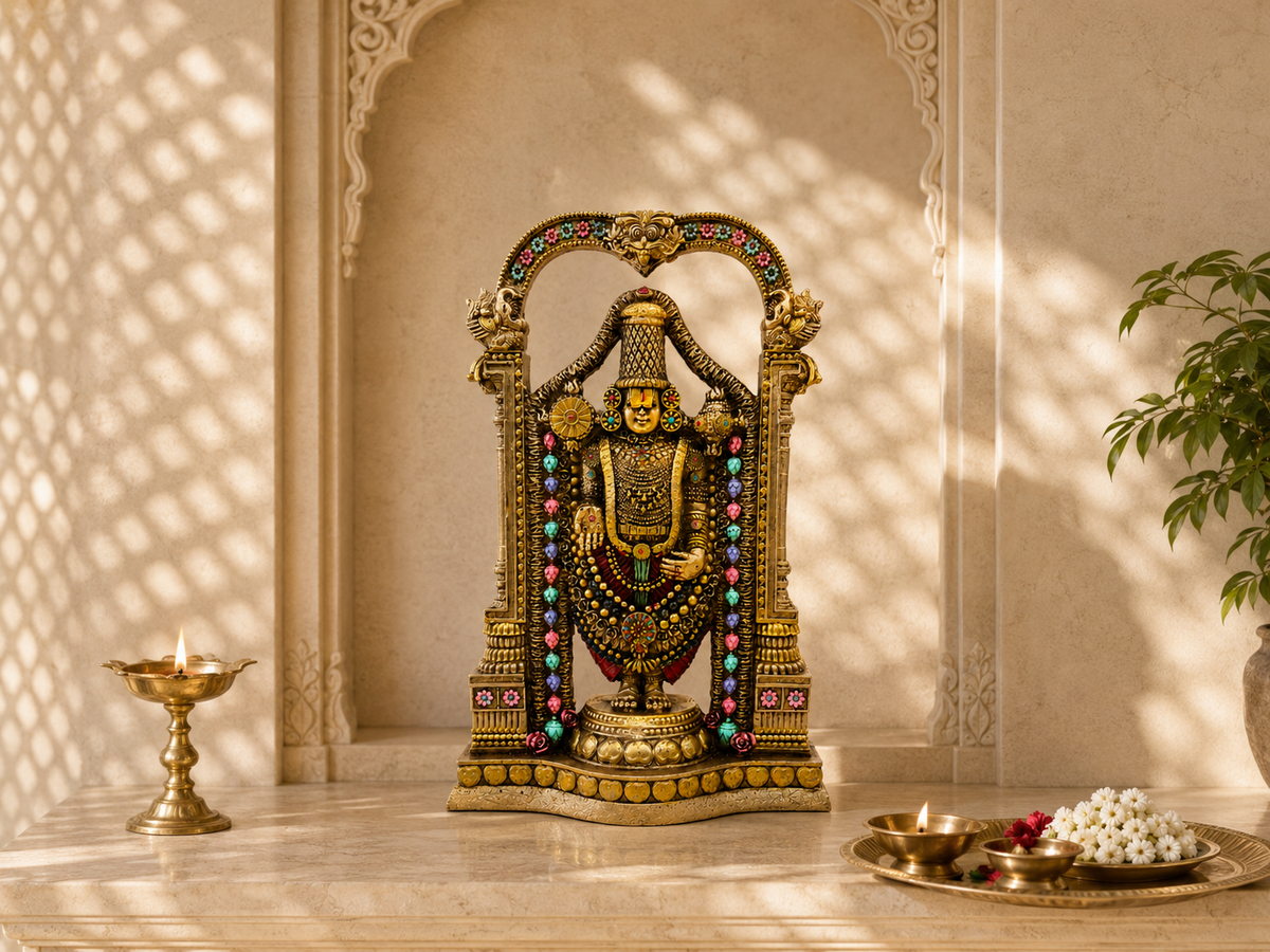 Tirupati Balaji idol displayed on a light stone home mandir counter with lamps and flowers