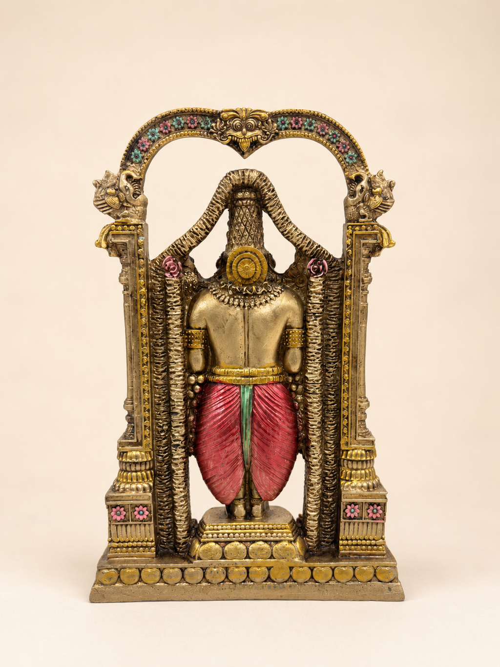 Rear view of the Tirupati Balaji idol showing the red garment and the floral arch