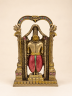 Rear view of the Tirupati Balaji idol showing the red garment and the floral arch