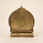Rear view of the Shiva Parvati Ganesha idol showing the gold-tone circular backdrop and patterned base