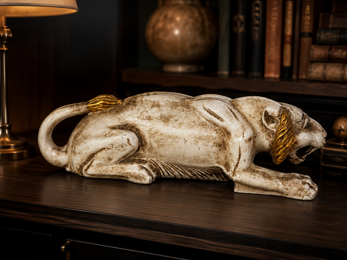 White and gold prowling tiger sculpture styled in a dark study