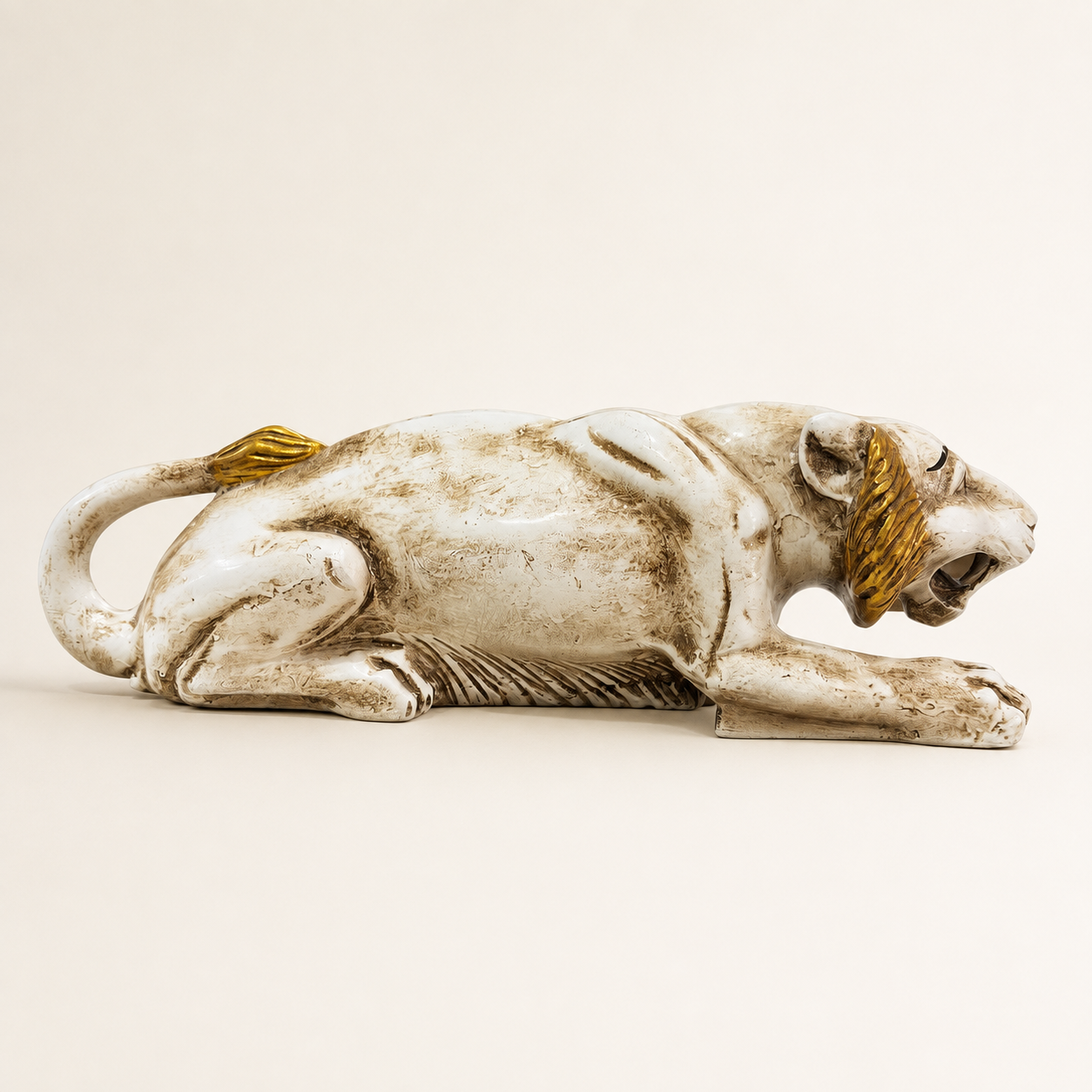 White and gold prowling tiger decorative sculpture, profile view
