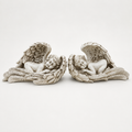 Pair of antique ivory sleeping angel wing sculptures, front view