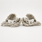 Pair of antique ivory sleeping angel wing sculptures, front view