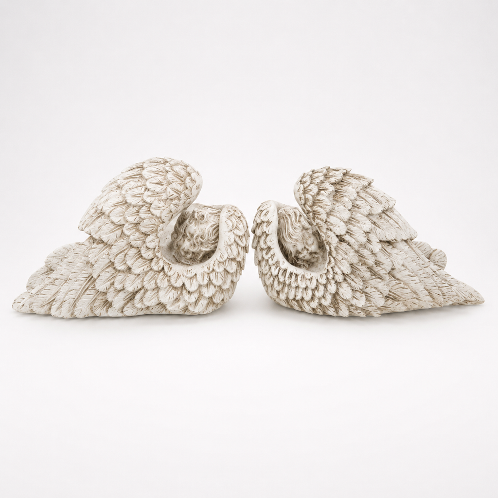 Pair of antique ivory sleeping angel wing sculptures, feathered reverse view