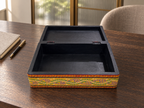 Open Surya Mandala keepsake box on a wooden desk, showing the black interior