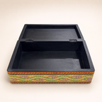 Surya Mandala keepsake box with hinged lid open, showing the black interior and storage compartment