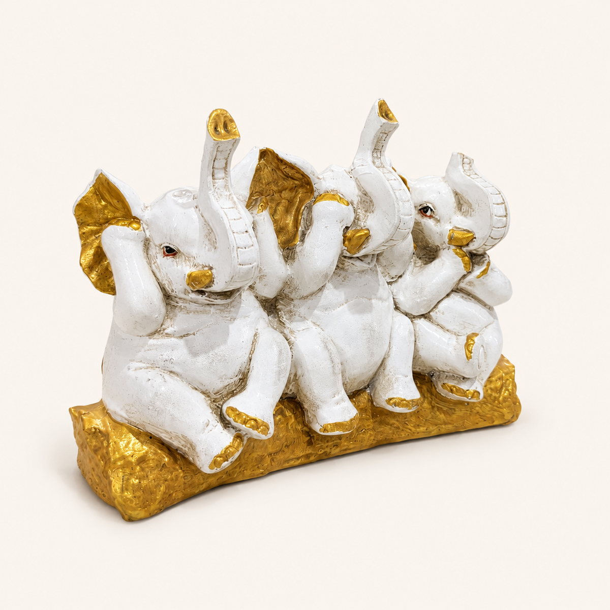 Three Wise Elephants ivory and gold decorative sculpture, left angled view