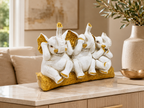 Three Wise Elephants ivory and gold sculpture styled on a console