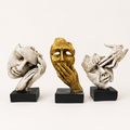 Unspoken Stories ivory and gold face sculpture trio on black bases, front view