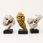 Unspoken Stories ivory and gold face sculpture trio on black bases, front view