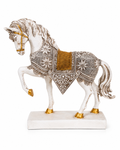 Side view of white and gold ornate prancing horse sculpture